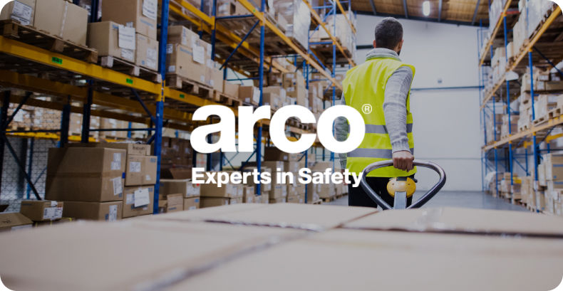 Warehouse employee walking through warehouse with Arco logo overlay